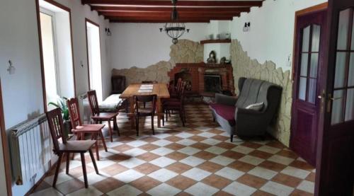 a living room with a table and chairs and a fireplace at Ranczo u Andrzeja in Rybaki