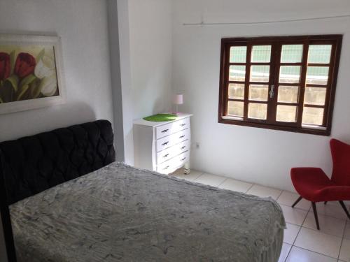 een slaapkamer met een bed, een dressoir en een raam bij Pousada Boulevard in Florianópolis