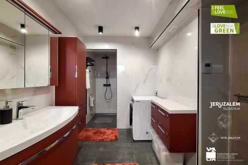 a bathroom with a tub and a sink and a shower at POD OREHI - Hiša na podeželju - RAZPRŠENI HOTEL Jeruzalem Slovenija in Miklavž pri Ormožu