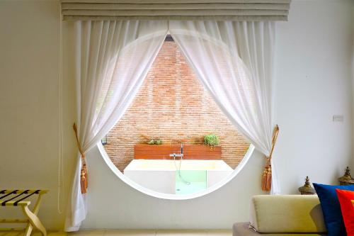 a room with a large window with a sink at Cae Villa Hua Hin in Hua Hin