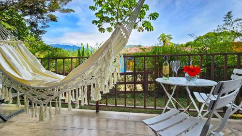 a patio with a hammock and a table and chairs at The Residence by Villa Alejandro in Boquete