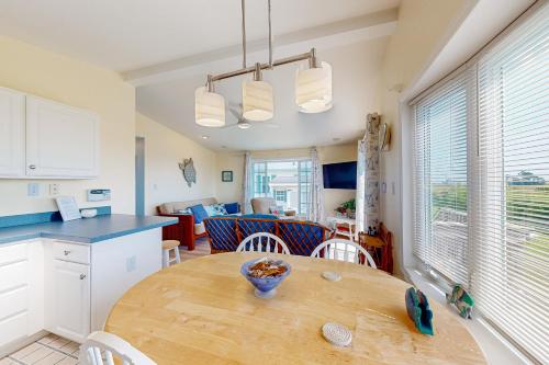 a kitchen and dining room with a wooden table at Bay-View Beauty in Assateague Point in Berlin
