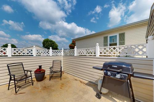 a grill on a patio with a white fence at Bay-View Beauty in Assateague Point in Berlin