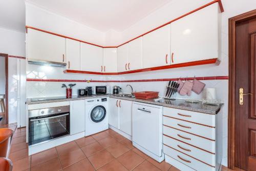 a kitchen with white cabinets and a dishwasher at Peaceful 1 BDR Apartment W/ Balcony by LovelyStay in Almancil