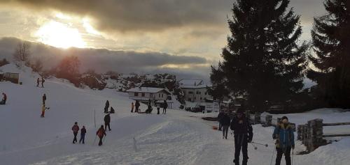 a group of people skiing down a snow covered slope at PALAZZO NOVECENTO Centro Storico in Lecco