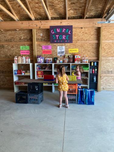 a little girl is standing in a book store at Glenn Meadow Bed and Breakfast in South Haven