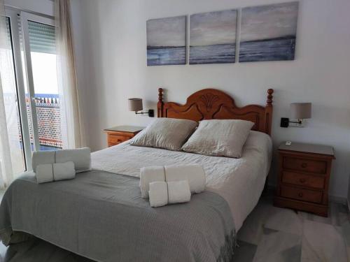 a bedroom with a large bed with two pillows on it at Primera línea de Playa in Almuñécar