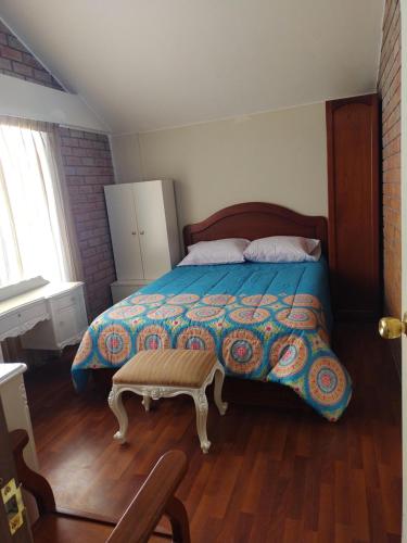 a bedroom with a bed and a table in it at House garden airport in Zamacola