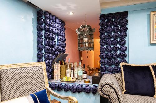 a room with two chairs and a table with bottles of wine at Luxury apartment in Venice in Venice