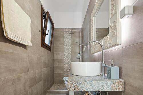 a bathroom with a sink and a mirror at Casa Di Sofia in Rethymno