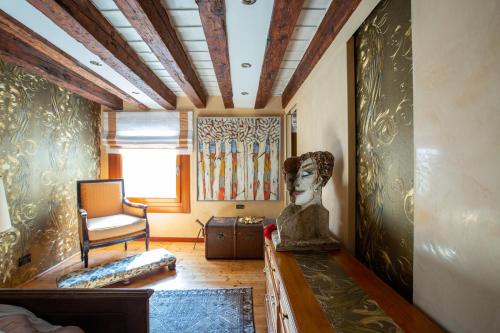 a room with a statue of a head on a table at Luxury apartment in Venice in Venice