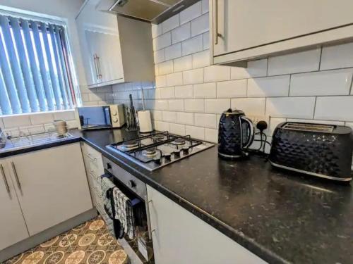 a kitchen with a stove and a counter top at K Suites - Harrogate Terrace in Bradford