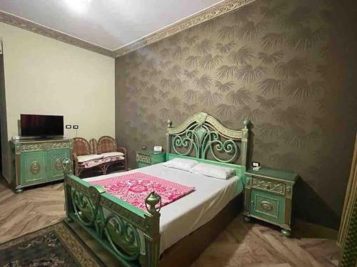 Bright And Vintage 3 BR Suite في القاهرة: غرفة نوم بسرير اخضر وبطانية وردية