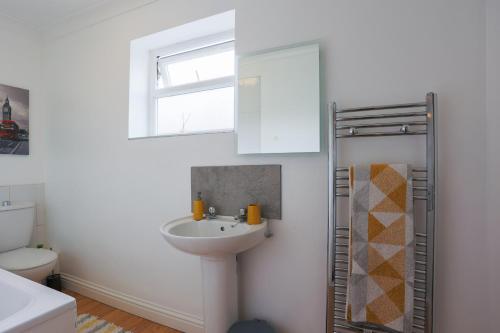 a bathroom with a sink and a toilet at The best flat on the street - Three minutes walk from the beach in Southend-on-Sea