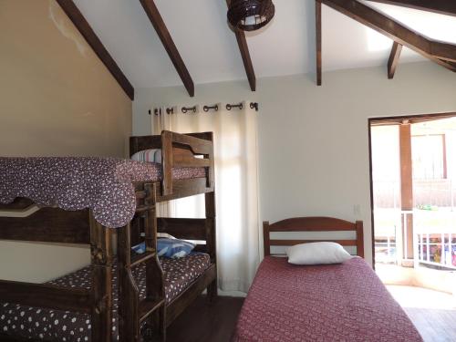 a room with two bunk beds and a window at Hostal Dinosaurio in Torotoro