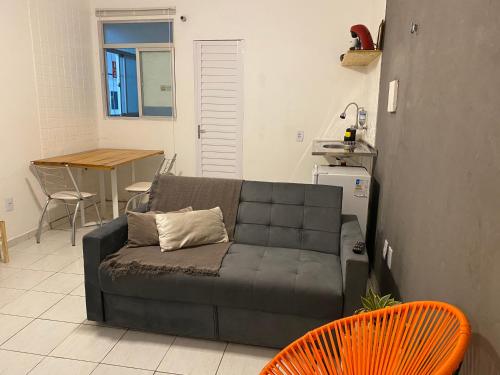 uma sala de estar com um sofá e uma mesa em Flat próximo ao Centro de CG com Wifi rápida em Campina Grande