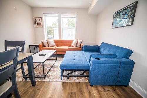 a living room with a blue couch and a table at The Josi:Elegant space and view in Washington, D.C.