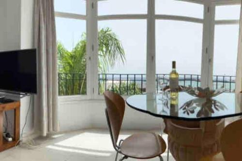 a living room with a glass table and a view of the ocean at Sea&Harbour Arrecife in Arrecife