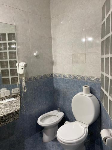 a bathroom with a toilet and a sink at San Remo City Hotel in Buenos Aires