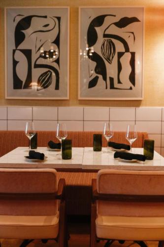 two tables in a restaurant with wine glasses on them at Virgin Hotels New Orleans in New Orleans