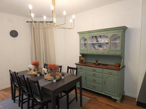 a dining room with a green cabinet and a table at Bethlehem Bliss:10min to Valley Festivals & Events in Bethlehem