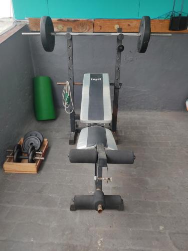 an overhead view of a gym with a bench and weights at Patio Urbano Suites & beds in Montevideo