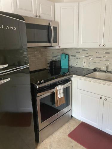 a kitchen with a stove and a microwave at Clearlake Cabins in Clearlake