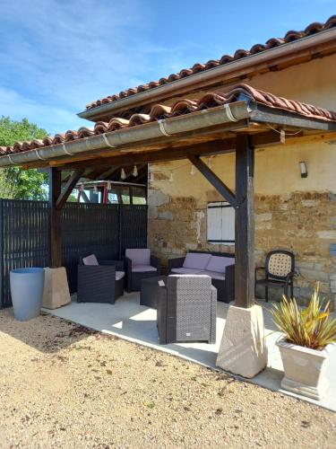 a patio with purple chairs and a pavilion at Le Campagnard & Le Maryline # Wifi # Clim # Parking Gratuit # Calme & Nature in Marboz