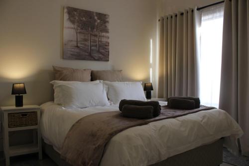 a bedroom with a large bed with two towels on it at 4499 Desert Rose in Swakopmund