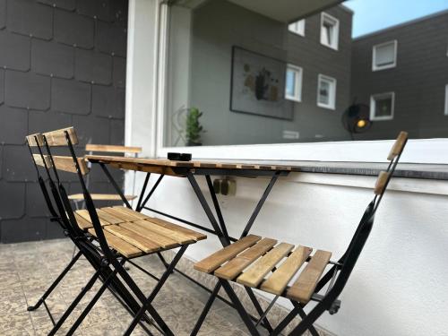 a table and two chairs sitting on a porch at Zentrales Apartment am Theater in Marl in Marl