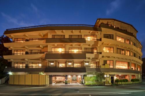 a large building with many windows at night at Maruei in Fujikawaguchiko