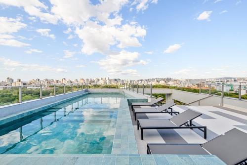 a pool on the roof of a building at Studio JP Redenção in Porto Alegre