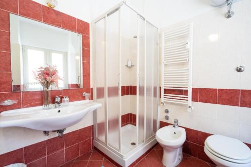 a bathroom with a sink and a toilet and a shower at Hotel Ascot in Rome