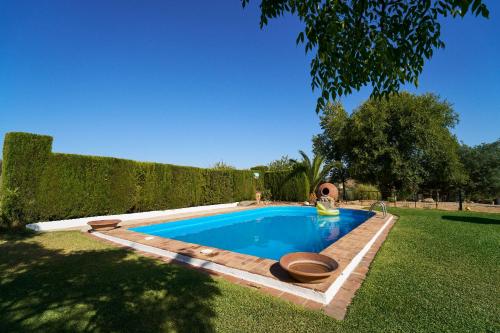 - une piscine avec 2 bols dans une cour dans l'établissement Villa Botero, à Constantina