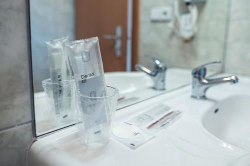 a bathroom counter with two sinks and a mirror at Penzion Hurikán 63 in Havlickuv Brod