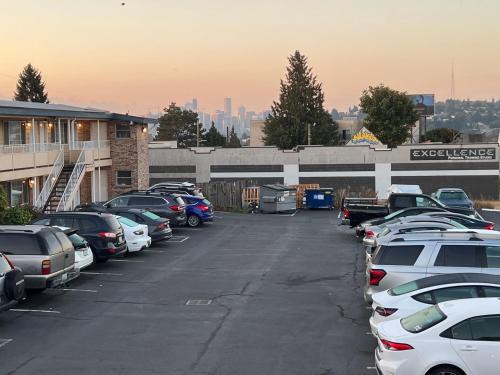 a parking lot with a lot of cars parked at Marco Polo Motel in Seattle