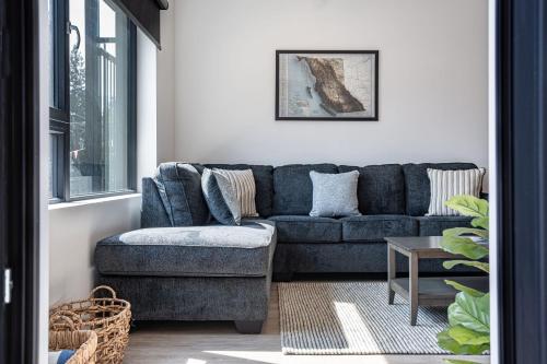 a living room with a blue couch and a table at The Grizzly Basin by Revelstoke Vacations in Revelstoke