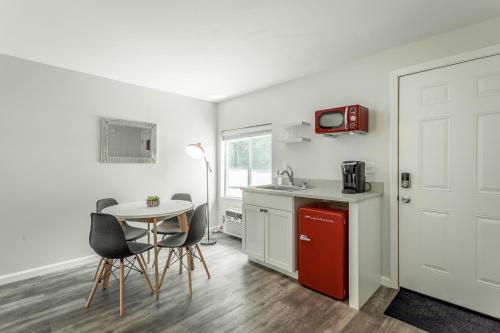 a kitchen with a small table and a red refrigerator at 01 The Eames Suite - A PMI Scenic City Vacation Rental in Chattanooga