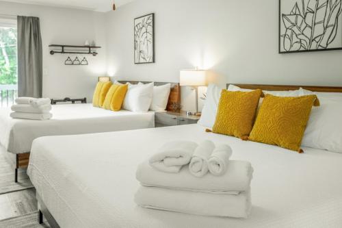 a bedroom with two beds with towels on them at 02 The Wright Suite - A PMI Scenic City Vacation Rental in Chattanooga