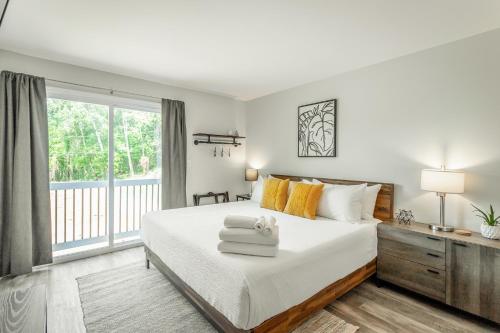 a bedroom with a bed with towels on it at 02 The Wright Suite - A PMI Scenic City Vacation Rental in Chattanooga