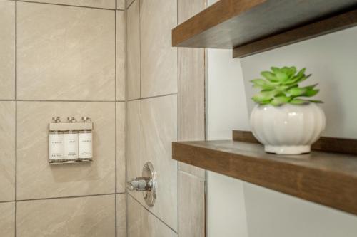 a white vase sitting on a shelf next to a shower at 02 The Wright Suite - A PMI Scenic City Vacation Rental in Chattanooga