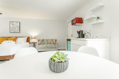 a white living room with a white table and a kitchen at 02 The Wright Suite - A PMI Scenic City Vacation Rental in Chattanooga