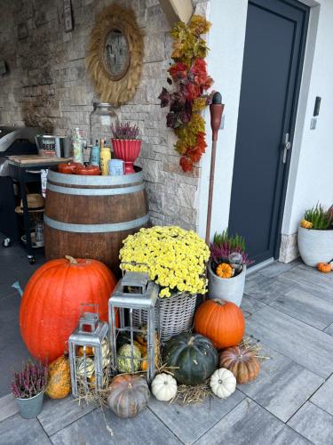 a bunch of pumpkins sitting next to a barrel at Apartmany pod Pustevnami in Prostřední Bečva