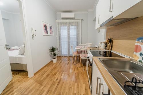 a kitchen with a sink and a counter top at The Little Pigeon - Pink in Ioannina