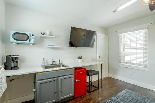 a kitchen with a sink and a red refrigerator at 06 The Mollino Room - A PMI Scenic City Vacation Rental in Chattanooga