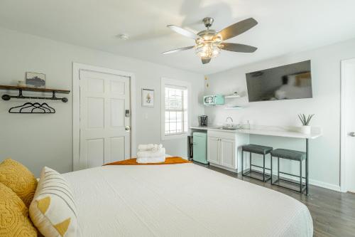a white bedroom with a bed and a ceiling fan at 05 The Finn Room - A PMI Scenic City Vacation Rental in Chattanooga