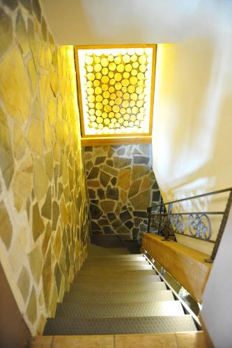 a stairway with a window and a stair case at Garnì Astoria Hotel & SPA in Roccaraso