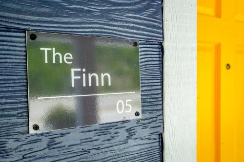 a sign that says the firm on a wall at 05 The Finn Room - A PMI Scenic City Vacation Rental in Chattanooga