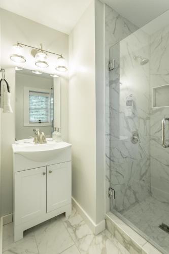 a white bathroom with a sink and a shower at 07 The Gio Room - A PMI Scenic City Vacation Rental in Chattanooga