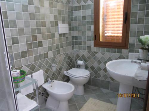 a bathroom with a toilet and a sink at Residence Olbia in Olbia